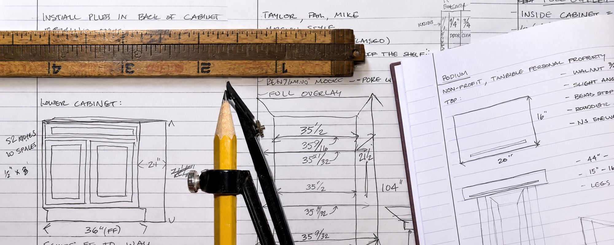 Working drawings for a cabinet and a walnut podium, with a folding rule and pencil dividers resting on the dimensioned notes