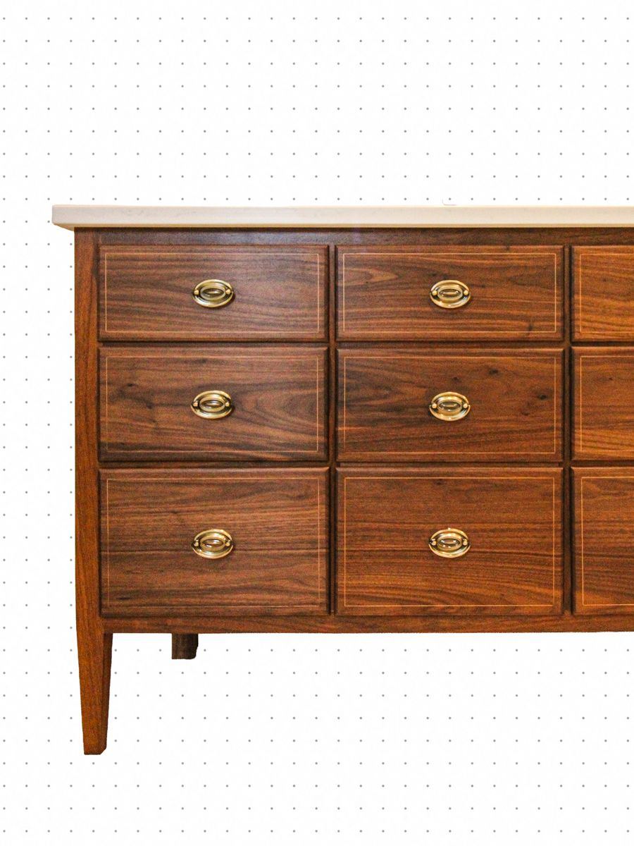 Walnut dresser with inlaid drawer fronts, brass pulls and a stone top