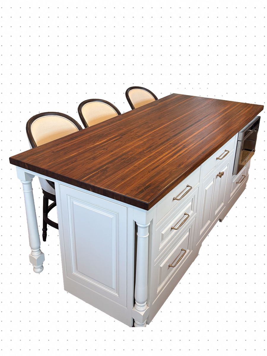 Kitchen island with a thick walnut top and painted turned legs